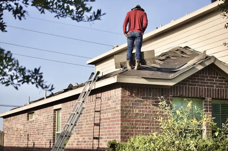 Professional roofer working on a residential roof in Fruitville